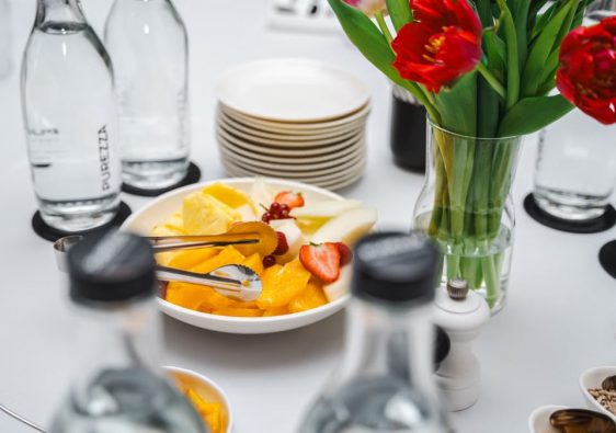 An elegant dining setup featuring fresh fruits and vibrant tulips, perfect for a healthy meal.
