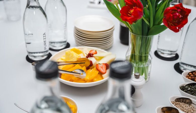 An elegant dining setup featuring fresh fruits and vibrant tulips, perfect for a healthy meal.